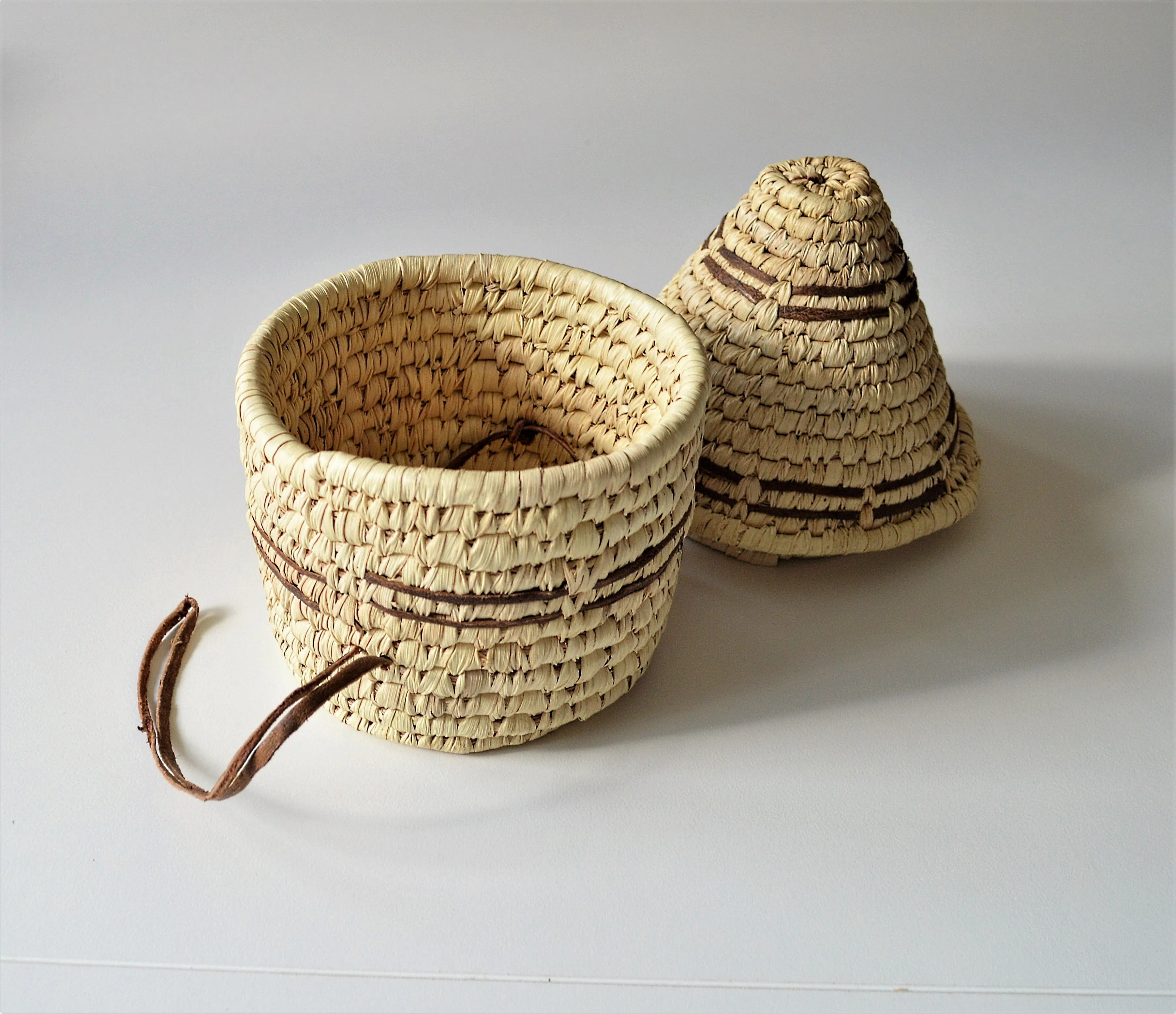 Woven palm leaf basket, Straw and leather wicker